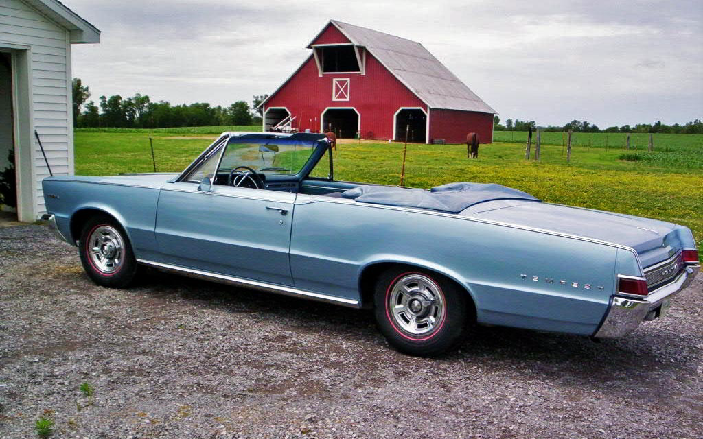 Pontiac Tempest in front of barn
