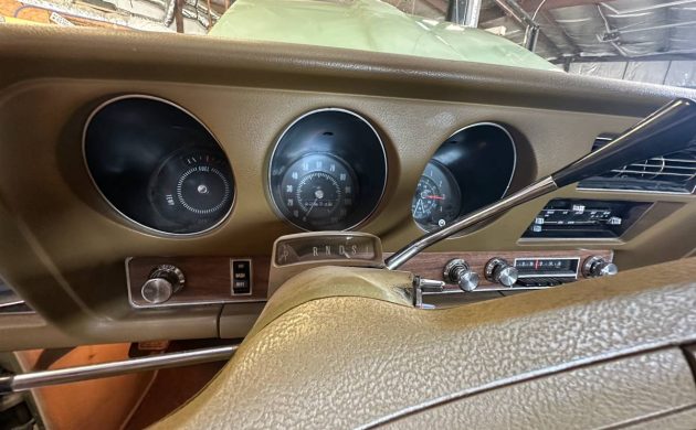 1969 Pontiac Tempest Custom S dashboard showing steering wheel, radio, and air-conditioning controls